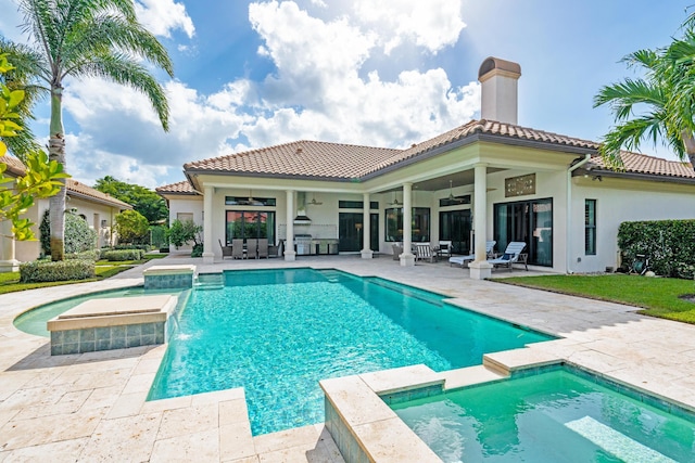 view of swimming pool featuring a patio, pool water feature, and ceiling fan