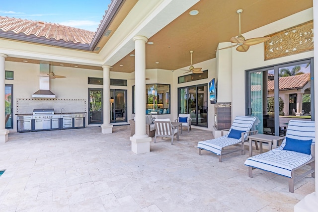 view of patio / terrace with area for grilling and ceiling fan