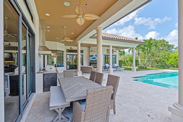 exterior space featuring ceiling fan, an outdoor living space, a patio, and an outdoor kitchen