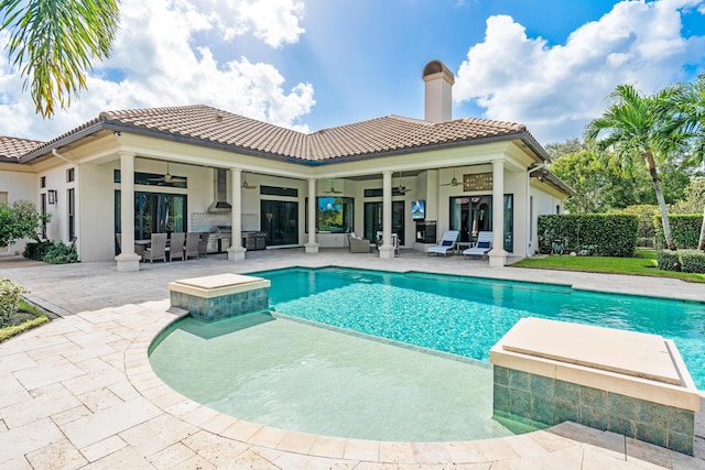 view of pool with ceiling fan and a patio