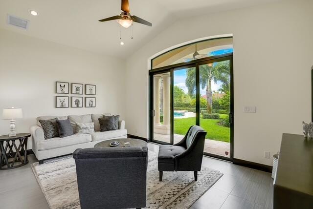 living room with ceiling fan and vaulted ceiling