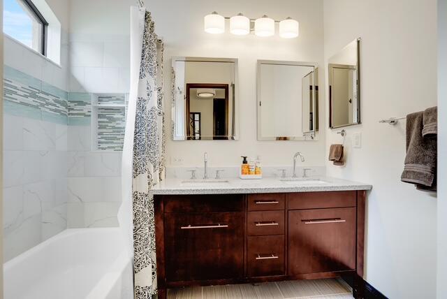 bathroom with vanity and tiled shower / bath combo