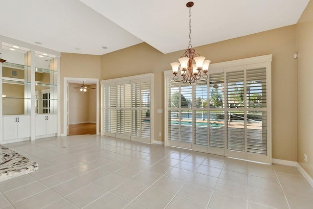 unfurnished room with light tile patterned floors, ceiling fan with notable chandelier, and baseboards