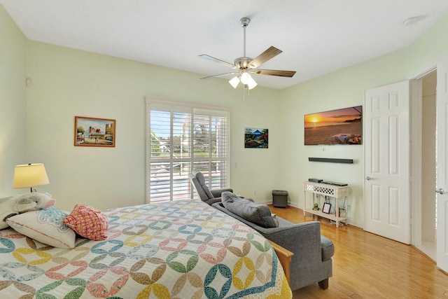 bedroom with light hardwood / wood-style floors and ceiling fan