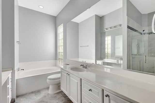 bathroom with a shower stall, a garden tub, vanity, and toilet