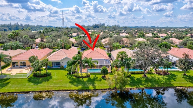 birds eye view of property with a water view and a residential view