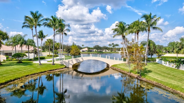 exterior space featuring a lawn and a water view