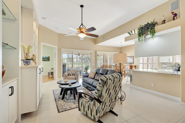 tiled living room featuring ceiling fan