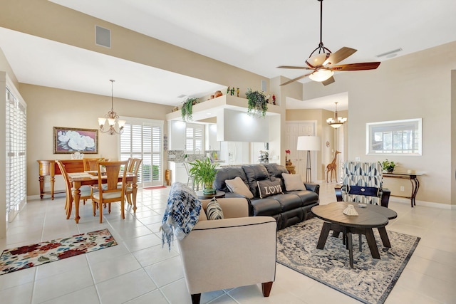 living room featuring ceiling fan with notable chandelier and light tile patterned floors