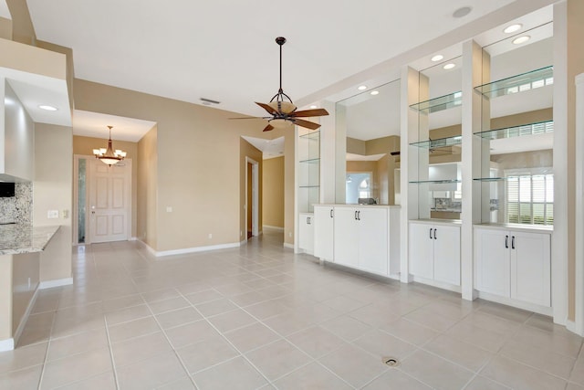 unfurnished living room with light tile patterned floors, baseboards, visible vents, ceiling fan with notable chandelier, and recessed lighting