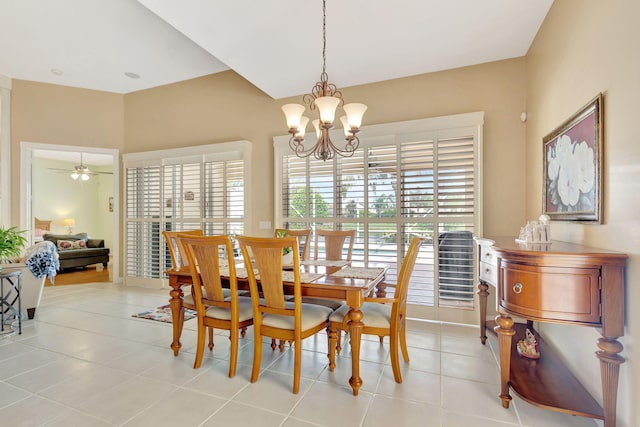 dining space with light tile patterned floors and ceiling fan with notable chandelier