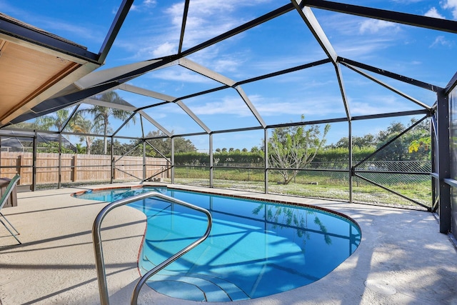 view of swimming pool with a lanai and a patio area