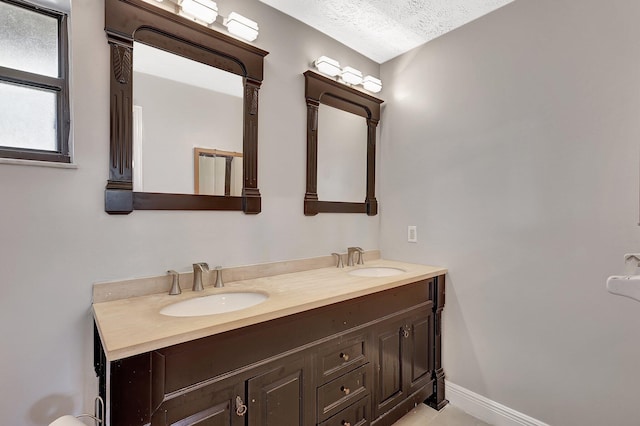 bathroom with vanity and a textured ceiling