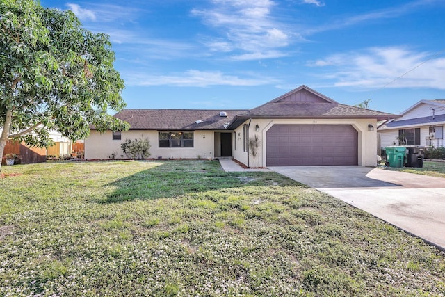 ranch-style home featuring a garage and a front lawn