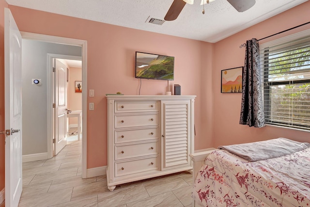 bedroom featuring a textured ceiling and ceiling fan