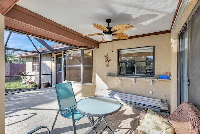 sunroom / solarium featuring ceiling fan