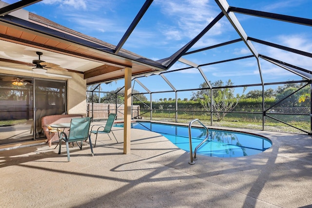 view of swimming pool with a lanai, ceiling fan, and a patio area