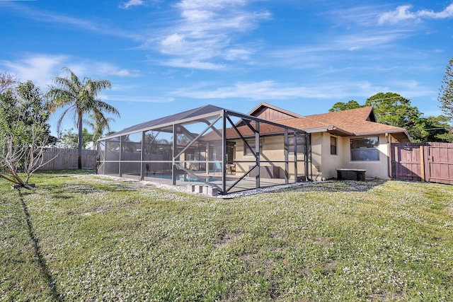 back of property with a lawn, a patio area, a lanai, and a fenced in pool