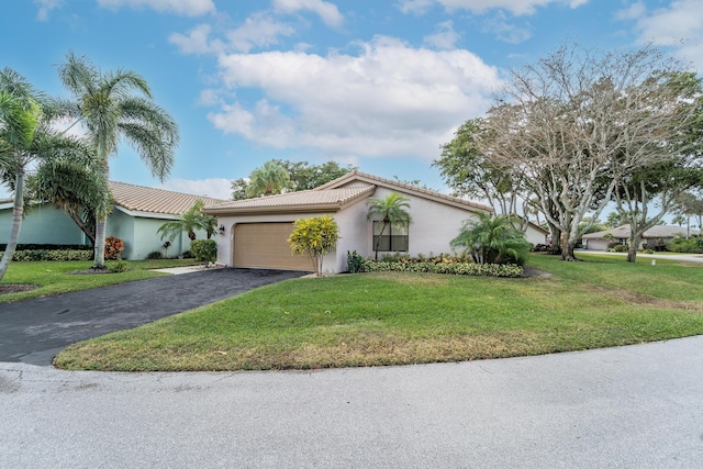 view of front of house with a garage and a front lawn