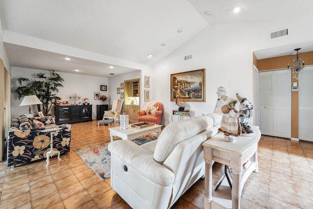 living room featuring lofted ceiling, light tile patterned floors, and an inviting chandelier