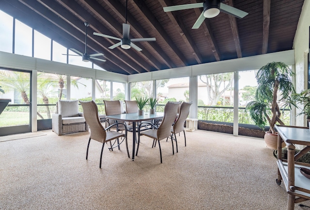 sunroom featuring a wealth of natural light, ceiling fan, and lofted ceiling with beams