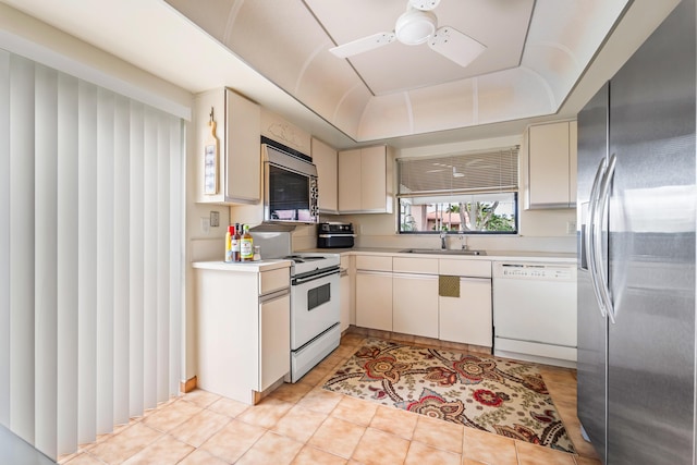 kitchen with ceiling fan, sink, light tile patterned floors, and stainless steel appliances