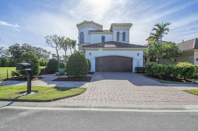 mediterranean / spanish-style home with a garage