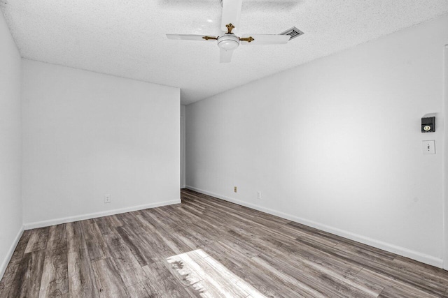 spare room with hardwood / wood-style floors, ceiling fan, and a textured ceiling