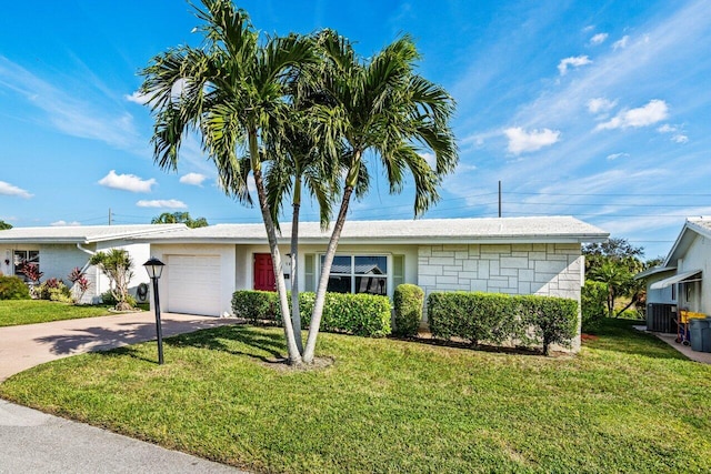 ranch-style home with central air condition unit, a front yard, and a garage