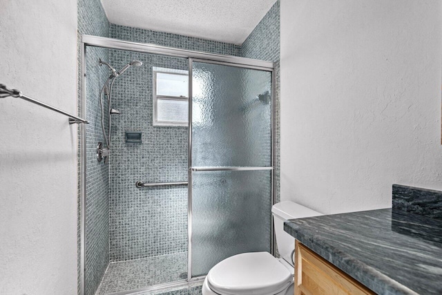 bathroom featuring an enclosed shower, vanity, and toilet