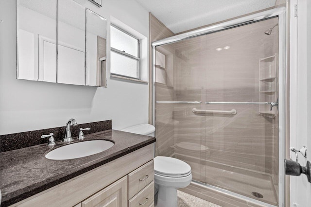 bathroom featuring walk in shower, vanity, and toilet