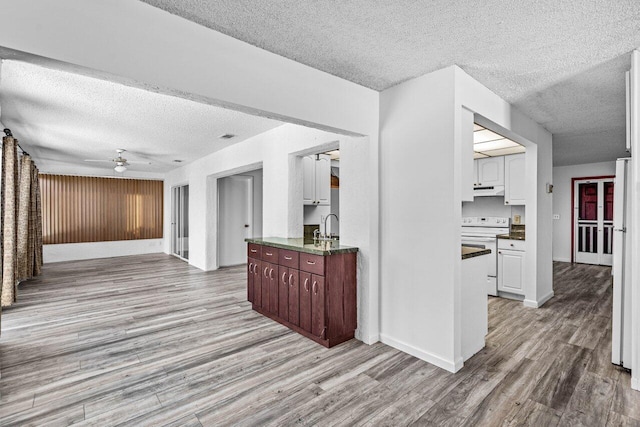 kitchen featuring white cabinetry, ceiling fan, sink, white appliances, and light wood-type flooring