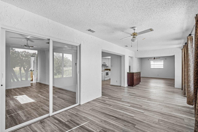 empty room featuring ceiling fan and light wood-type flooring