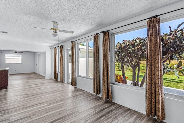 spare room with light hardwood / wood-style flooring and ceiling fan