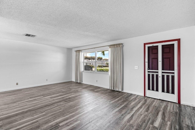 empty room featuring hardwood / wood-style floors and a textured ceiling