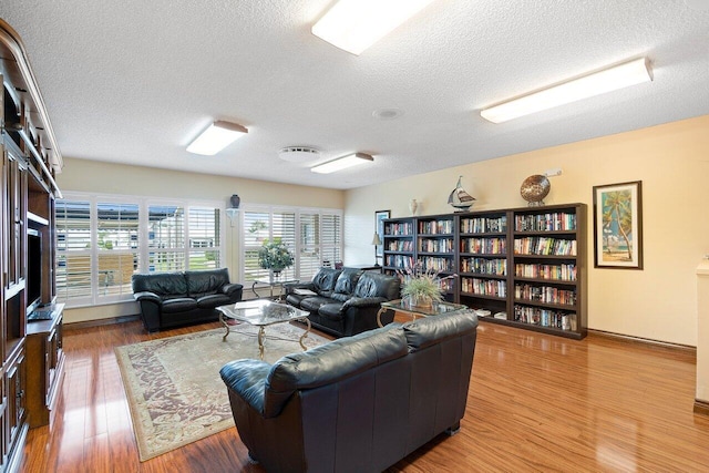 living room featuring hardwood / wood-style floors and a textured ceiling