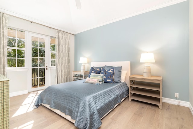 bedroom featuring ceiling fan, light wood-type flooring, and ornamental molding