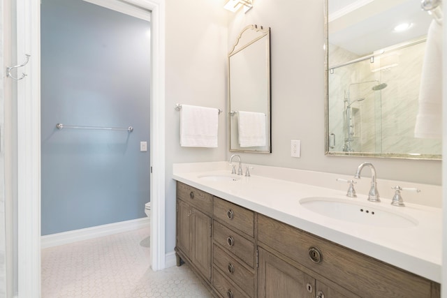 bathroom featuring tile patterned floors, vanity, toilet, and a shower with door