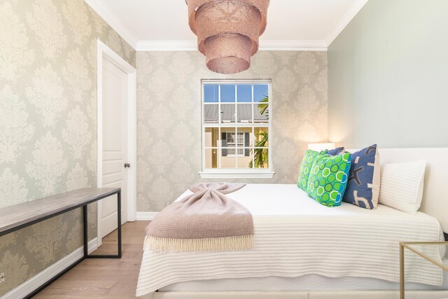 bedroom featuring hardwood / wood-style floors and ornamental molding