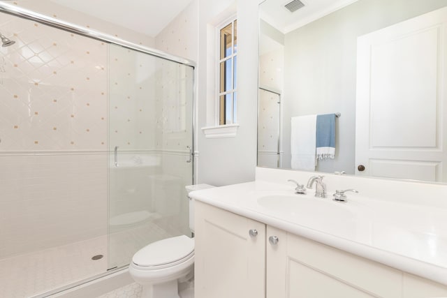 bathroom featuring vanity, toilet, ornamental molding, and walk in shower