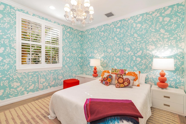 bedroom with light hardwood / wood-style floors, a notable chandelier, and ornamental molding