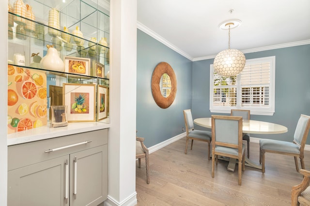 dining room featuring ornamental molding and light hardwood / wood-style flooring