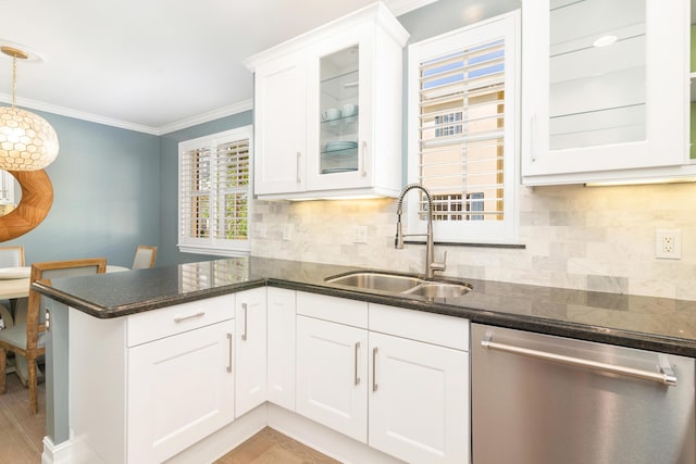 kitchen featuring dishwasher, sink, hanging light fixtures, backsplash, and white cabinets