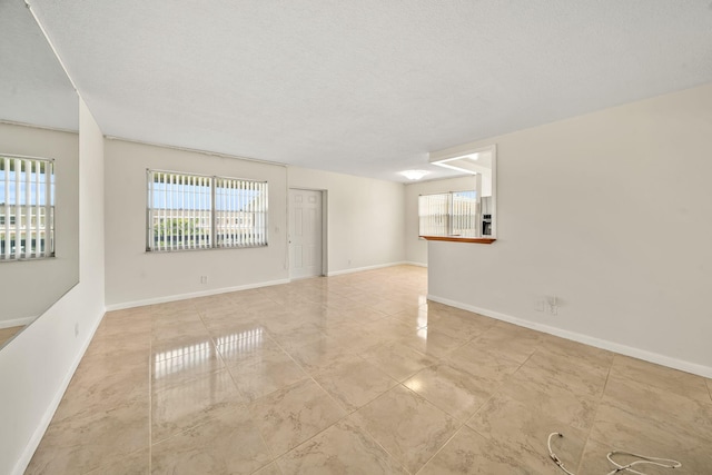 unfurnished room with a textured ceiling