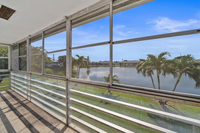 unfurnished sunroom with a water view