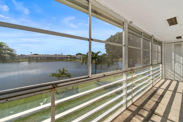 unfurnished sunroom with a water view