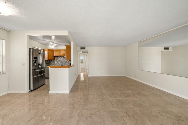 unfurnished living room with a textured ceiling