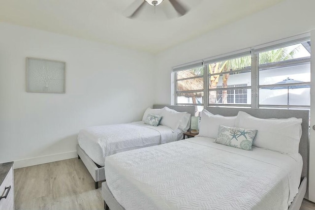 bedroom with ceiling fan and light hardwood / wood-style floors