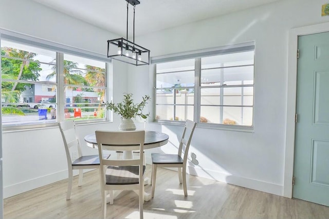 dining room featuring light hardwood / wood-style flooring and an inviting chandelier