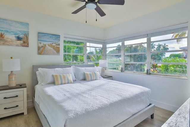 bedroom with ceiling fan and light wood-type flooring